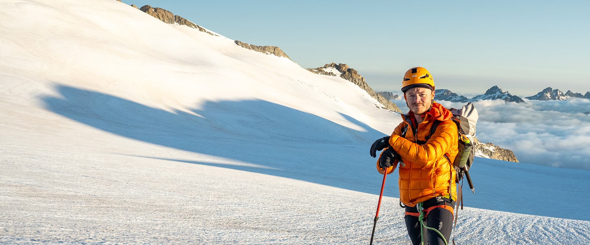 person in mountains with alpine gear