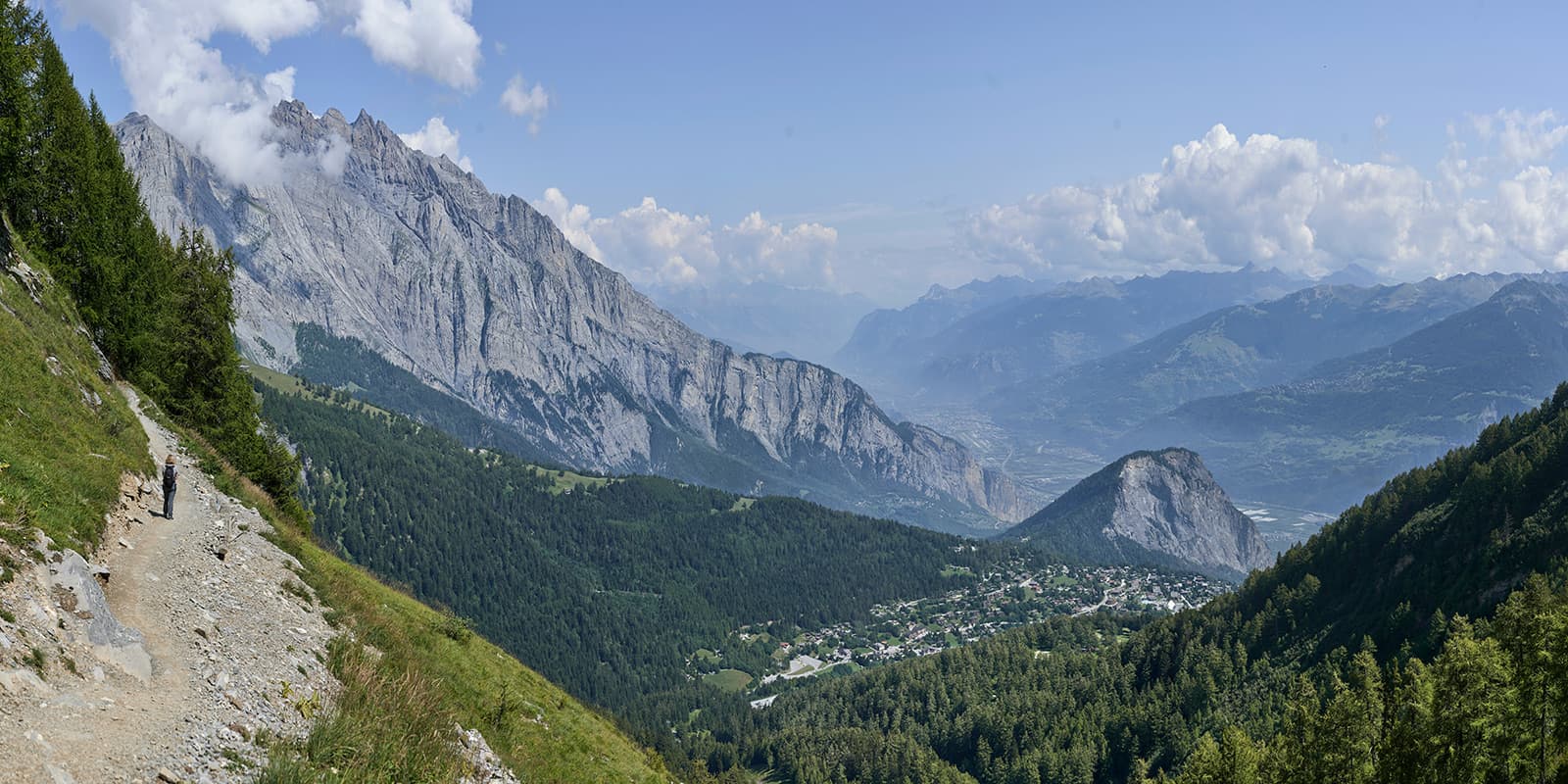 person hiking on small mountain path in the Swiss Alps on the Tour du Muverans