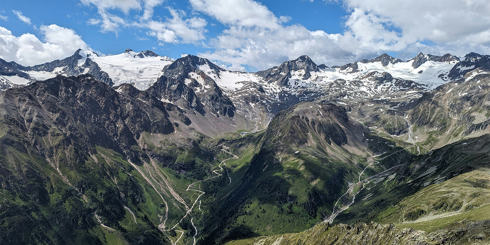 snowy mountains and green valley