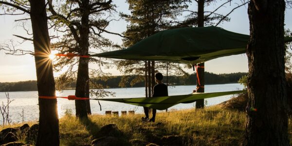 person in hammock overlooking a lake