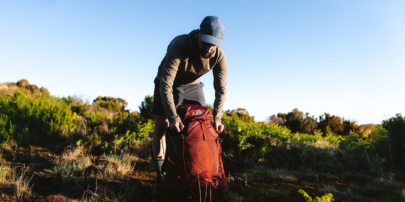 person setting down his Gregory backpack