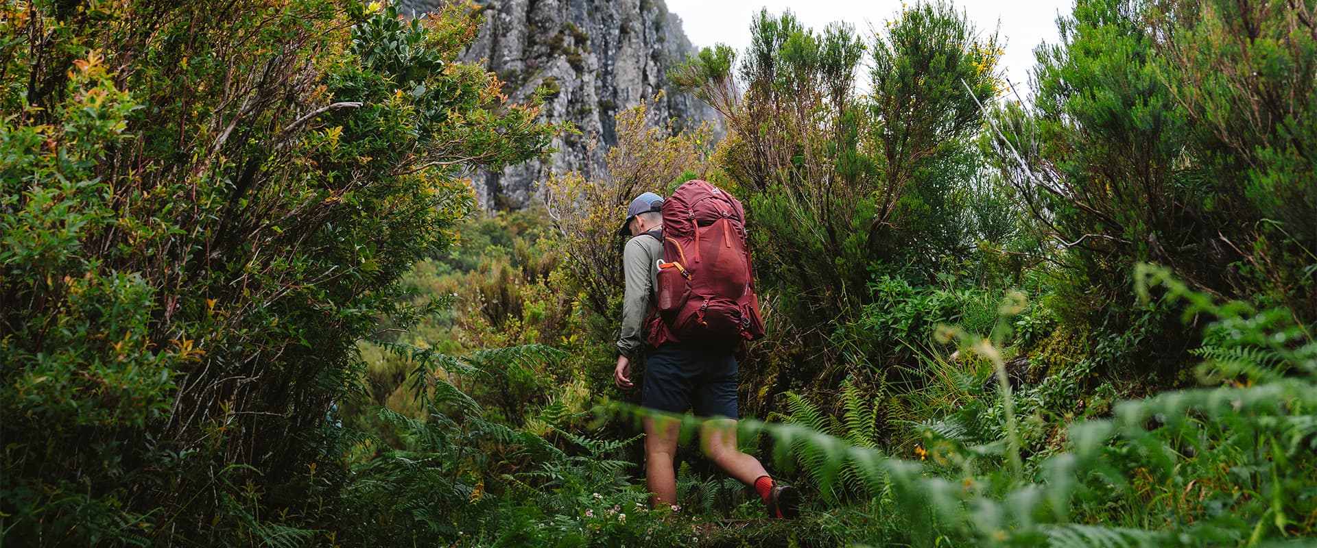 hiker going up a mountain in madeira in moody conditions