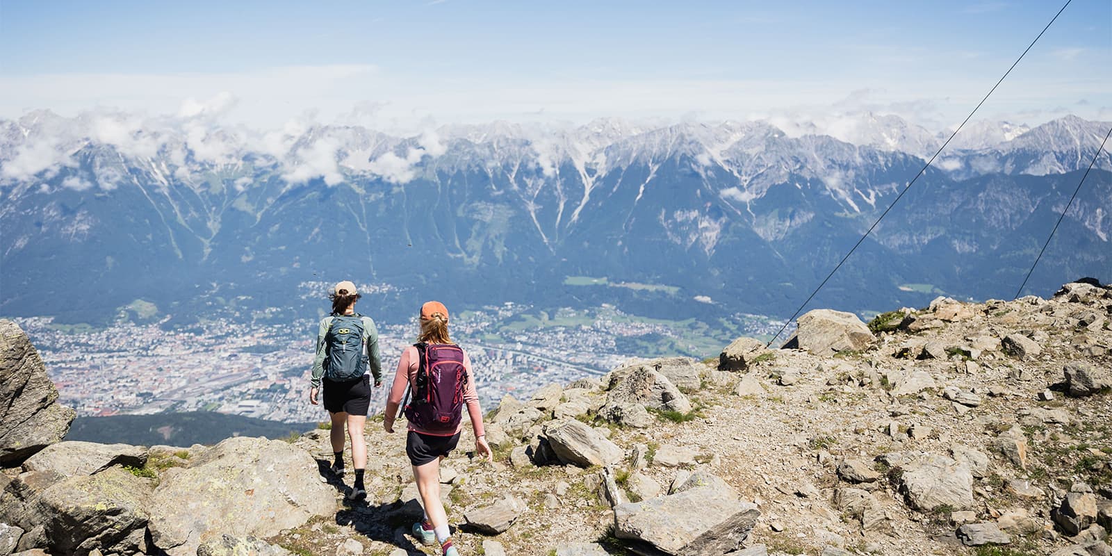 hikers on mountain top overlooking Innsbruck