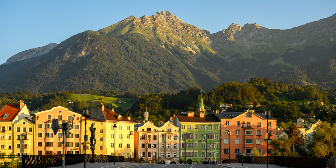 colorful houses in Innsbruck with mountains in background