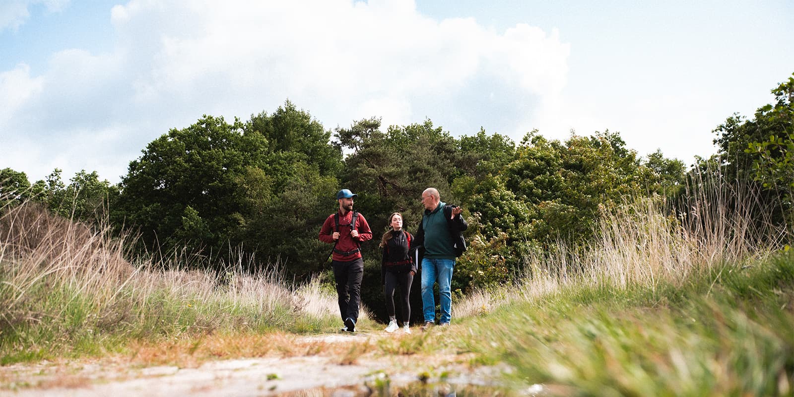guide talking to two hikers on nature trail in the Netherlands