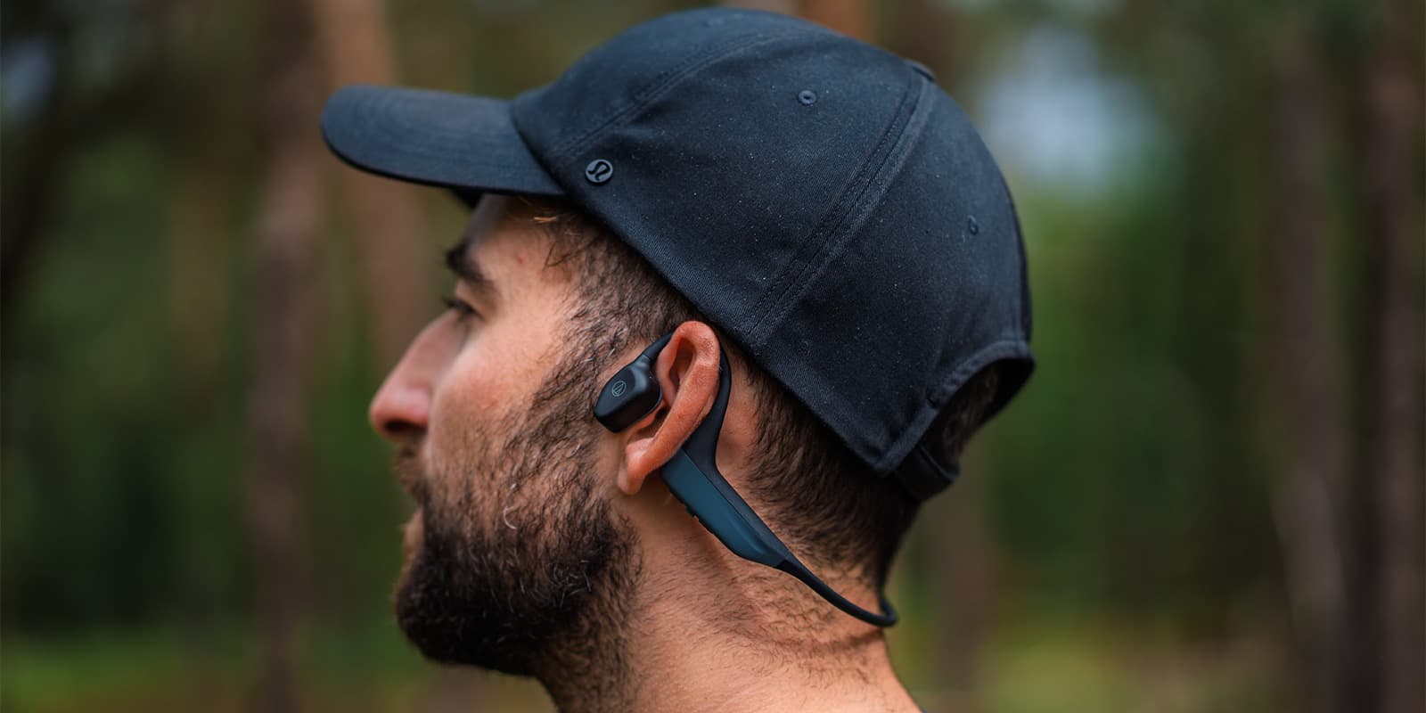 person wearing open-ear bluetooth headphone