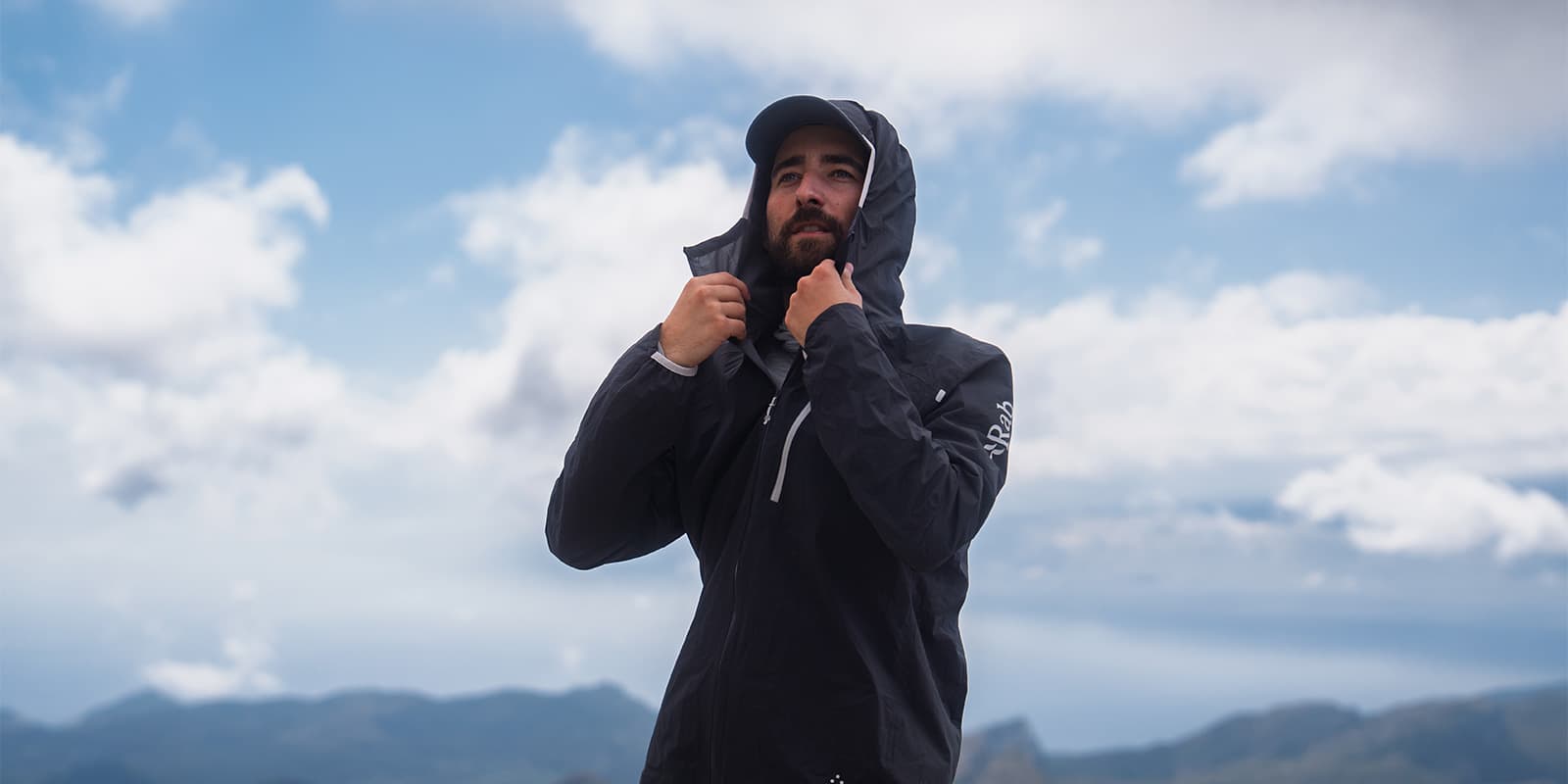 person wearing the RAB Downpour Trail light jacket