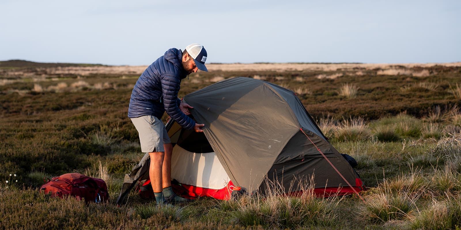person standing by his MSR Hubba Hubba tent in Englisch countryside