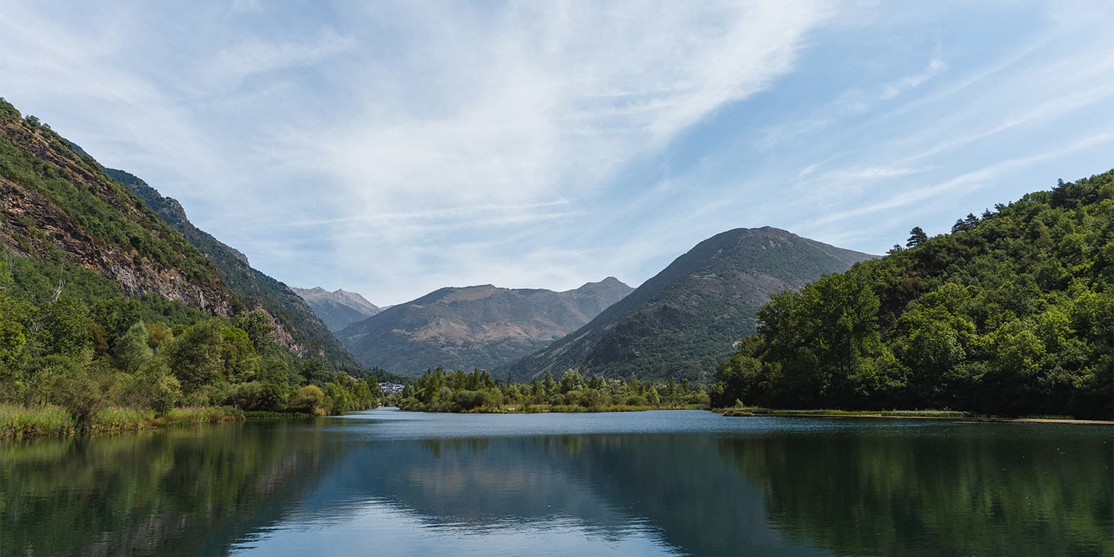 calm mountain lake with lush green forest