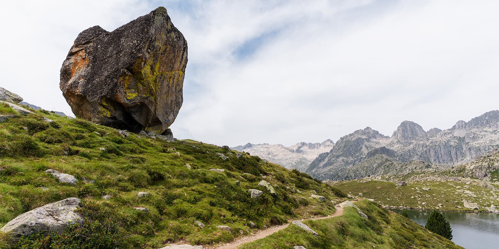 big stone next to hiking trail in the Aigüestortes National Park on the Via Calda