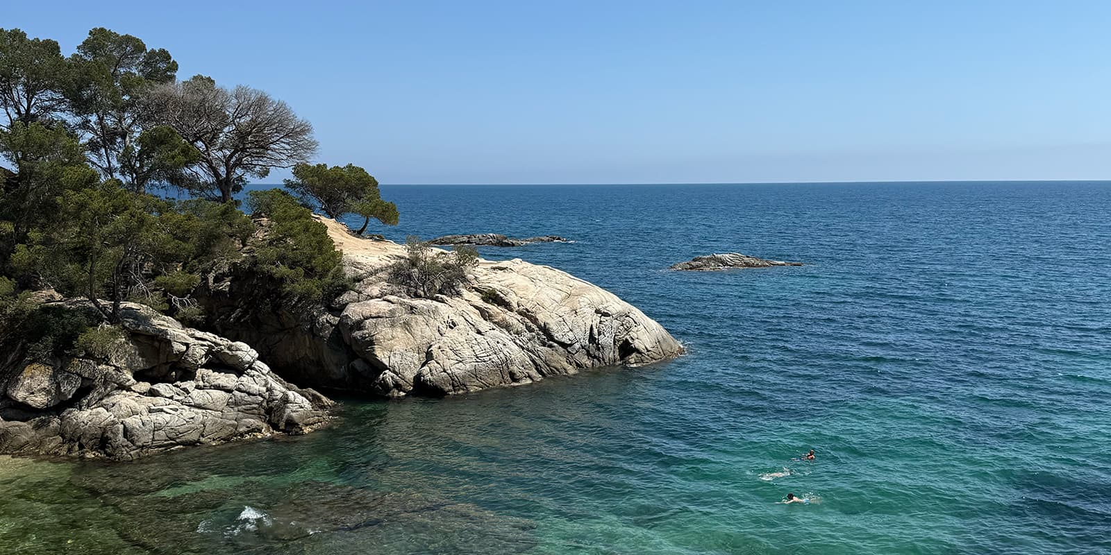 people swimming in the ocean on the Spanish coast
