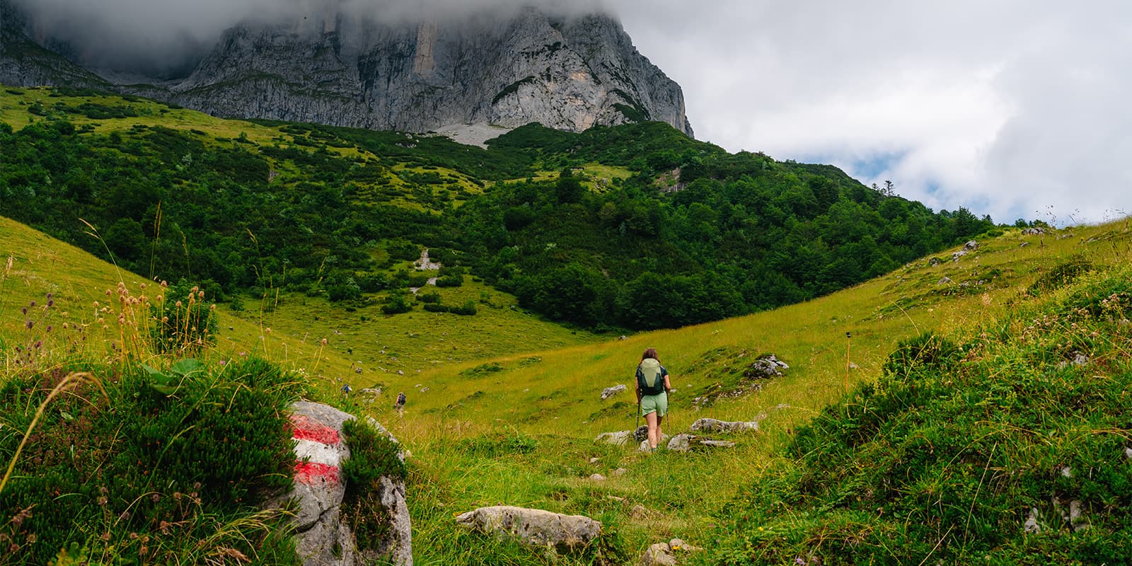 person hiking in mountain valley on the Adlerweg in Tirol