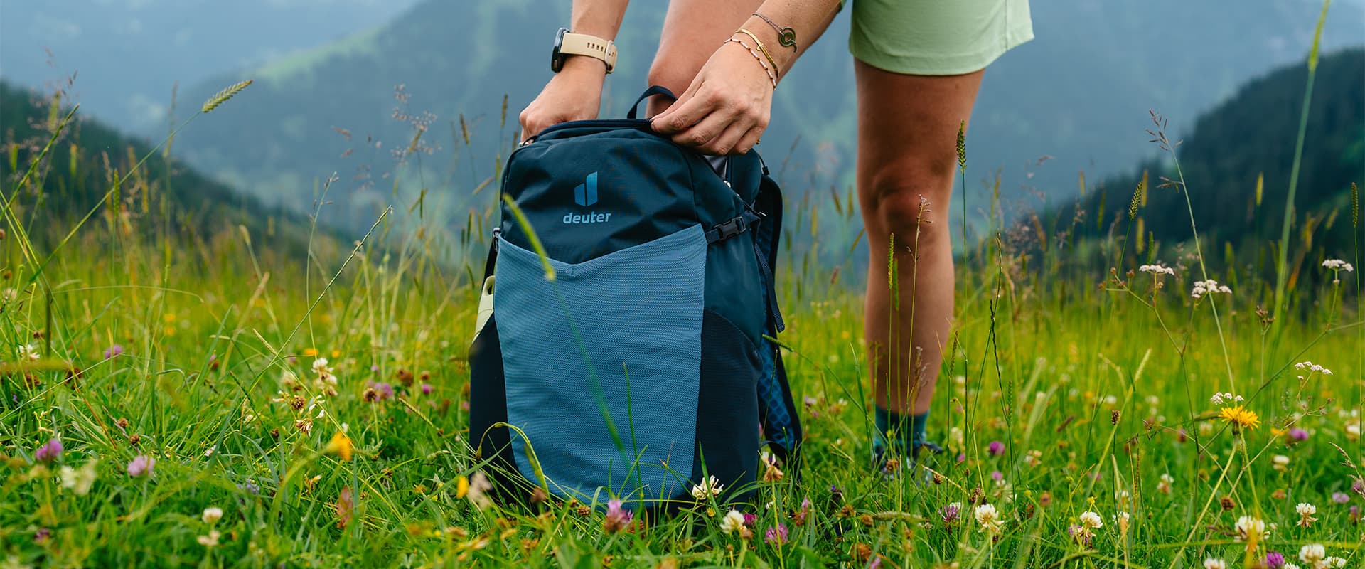 Deuter speed lite in the grass with mountains in the background