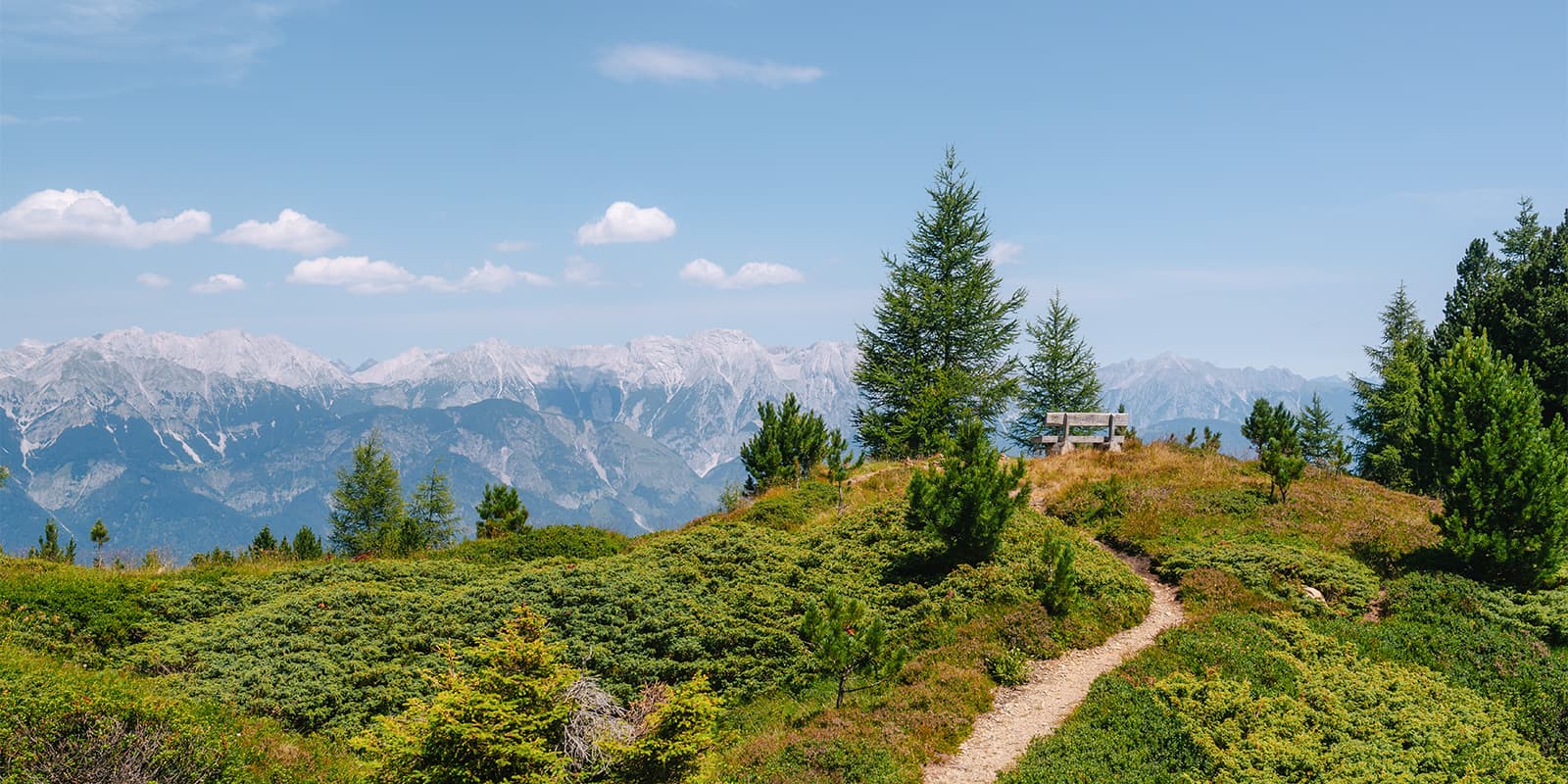 wooden bench overlooking the Innsbruck valley