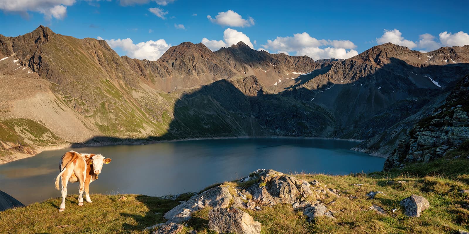 big mountain lake near mountains on the Sellrain Valley hut tour
