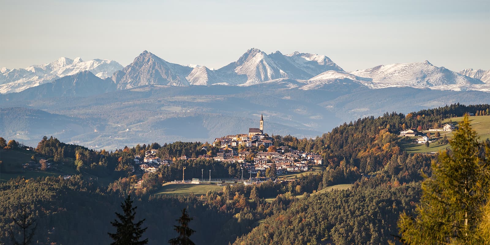small mountain village with Dolomites mountains in the background