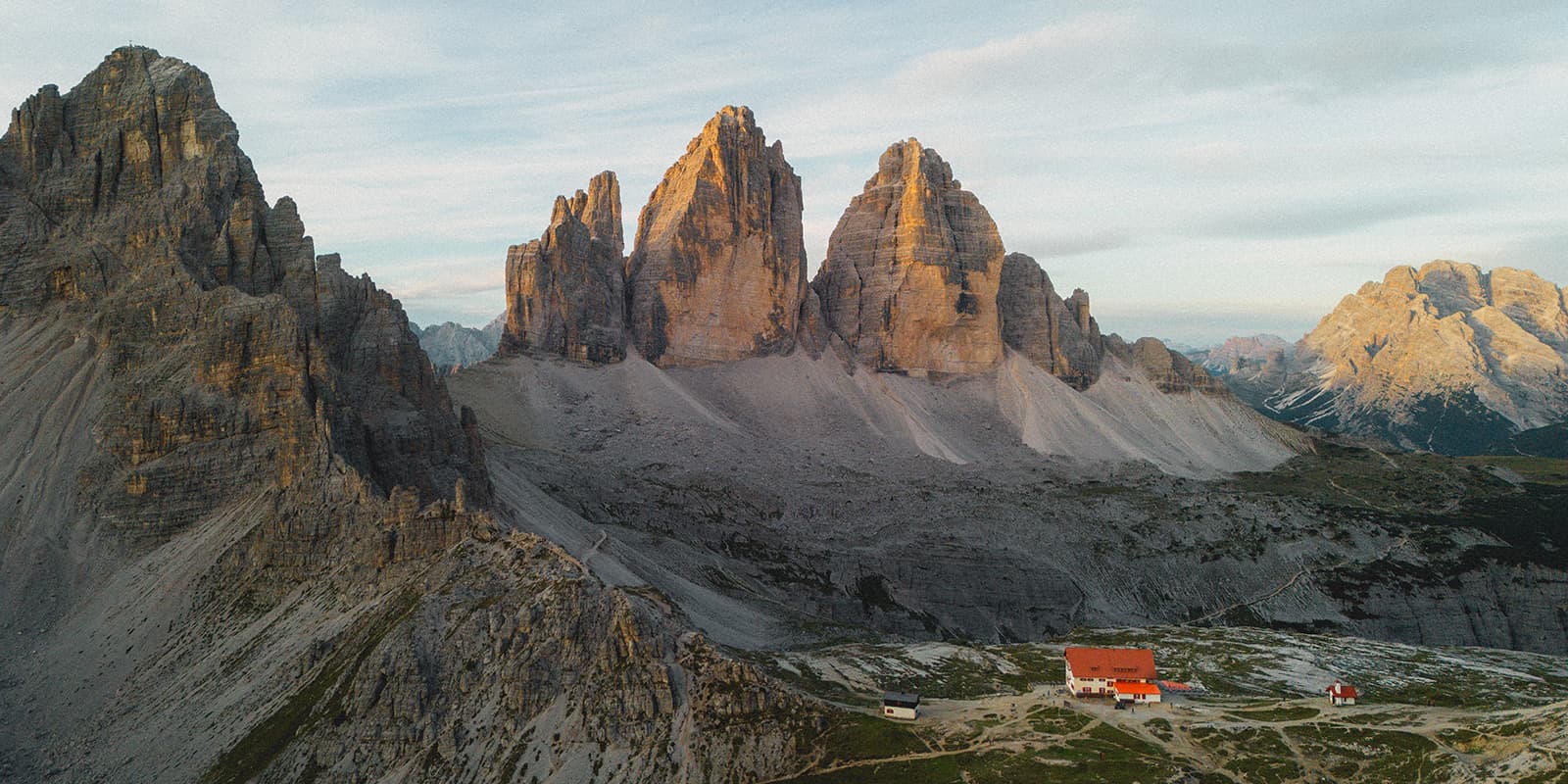 drone shot of the Tre Cime di Lavardo with mountain hut in the foreground
