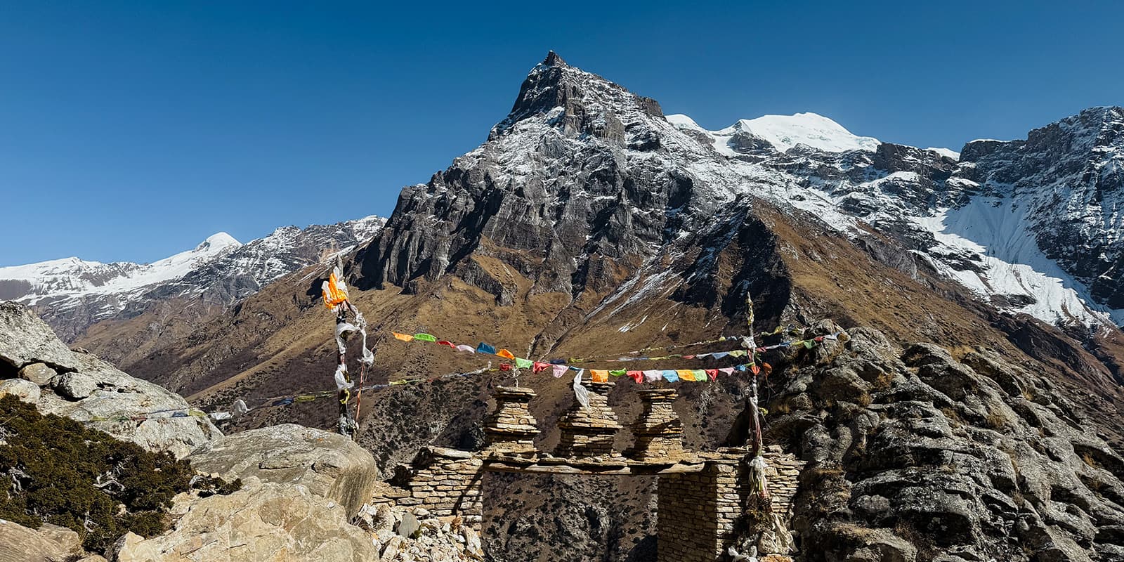 Nepali flags with big mountains in the background