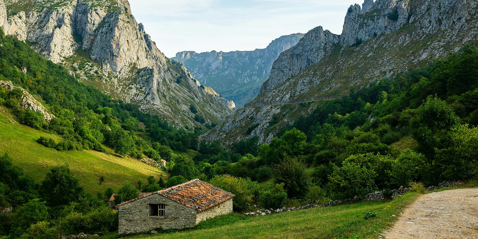old stone barn in mountain valley near dirt road in the Picos de Europa