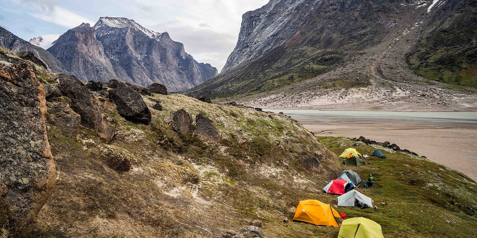 tents pitched near body of water in the north part of Canada