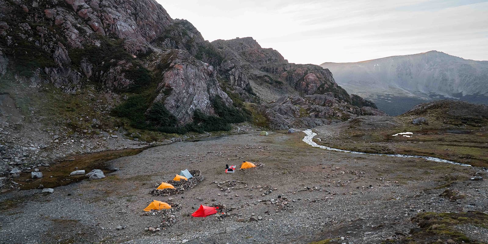 tents in mountain valley near river on the Dientes de Navarino circuit