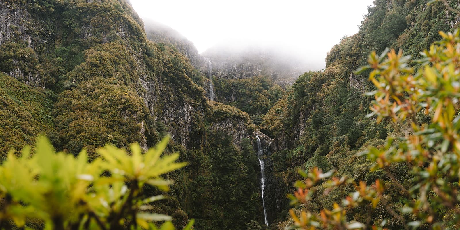 waterfall surrounded by green mountains on madeira