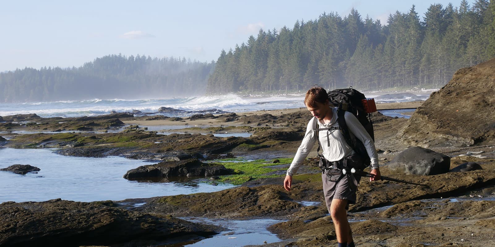 person hiking along the beach on the West Coast Trail