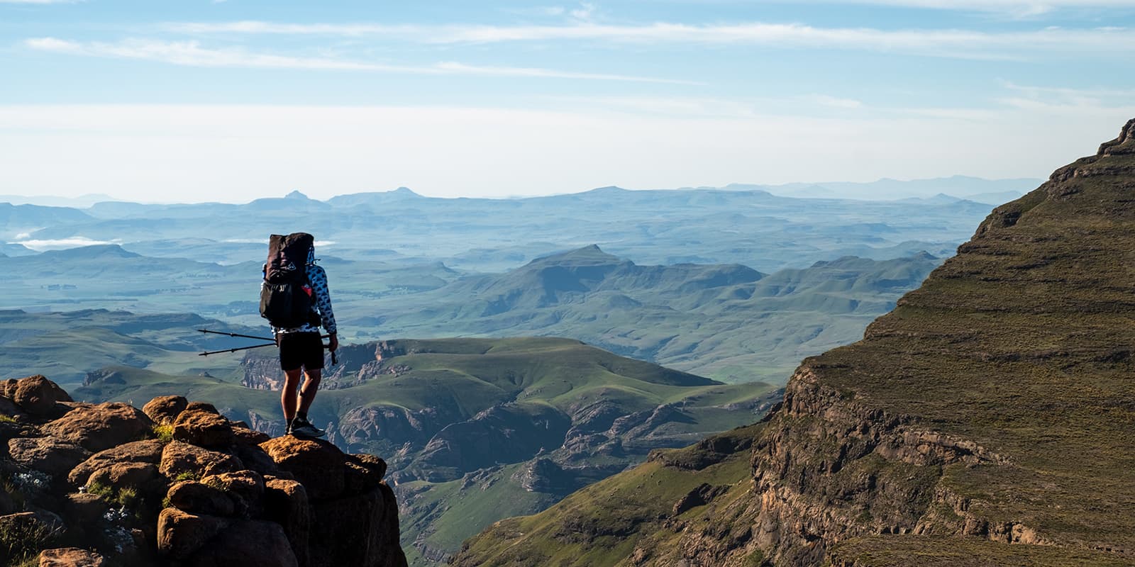 person overlooking mountain landscape on the Drakensberg Grand Traverse in South Africa
