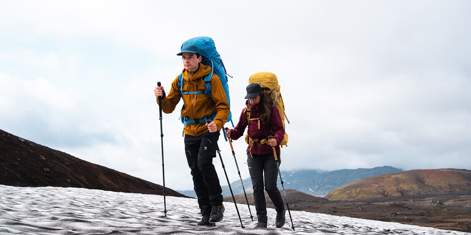 couple hiking in Iceland with Deuter backpacks and Leki poles