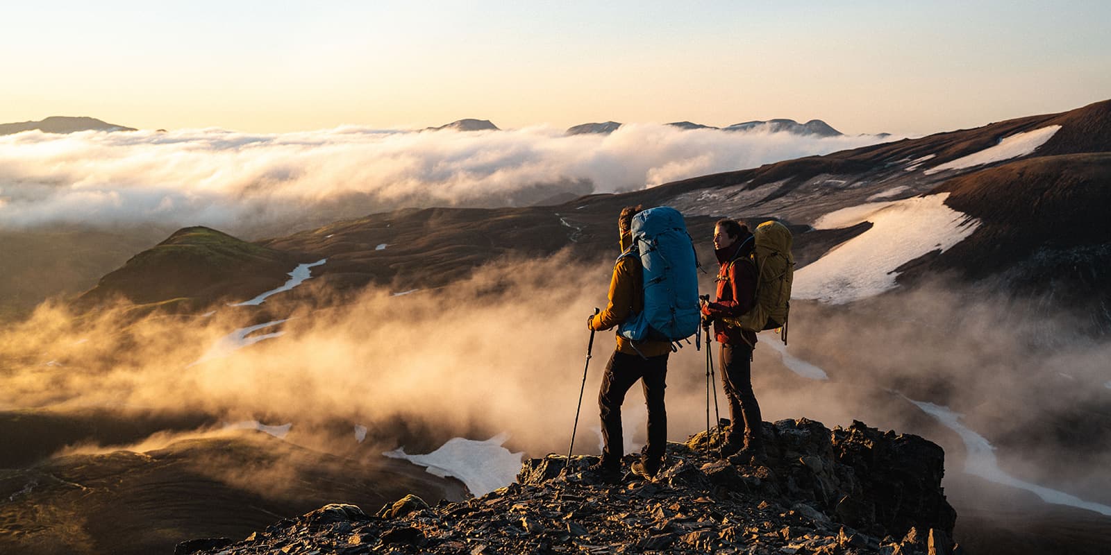 hikers overlooking the mountains of Iceland during sunrise