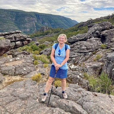person posing for a picture in the mountains