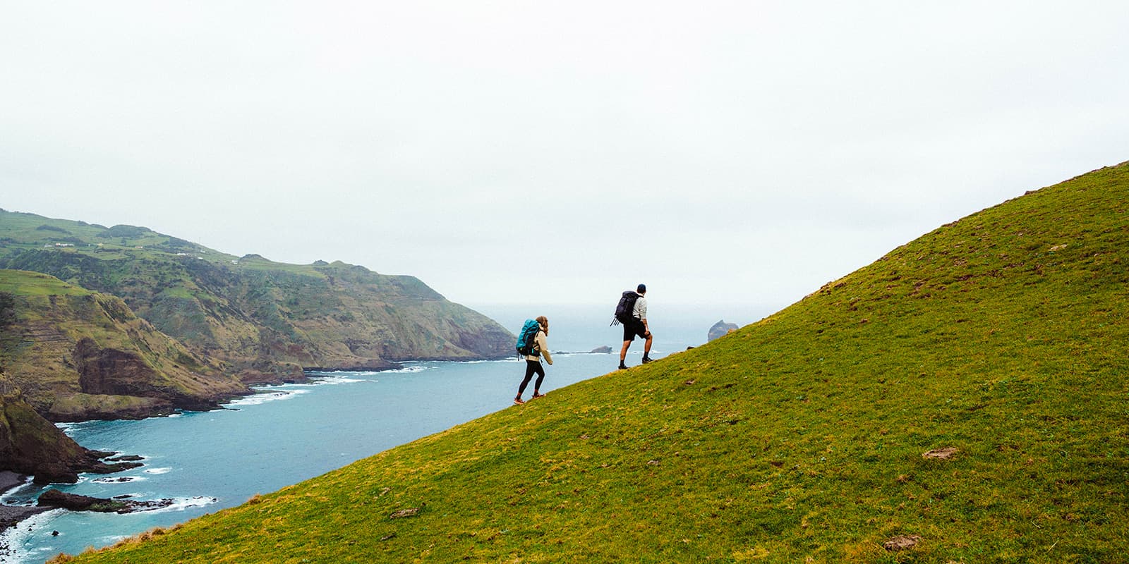couple hiking on the Azores with Osprey backpacks