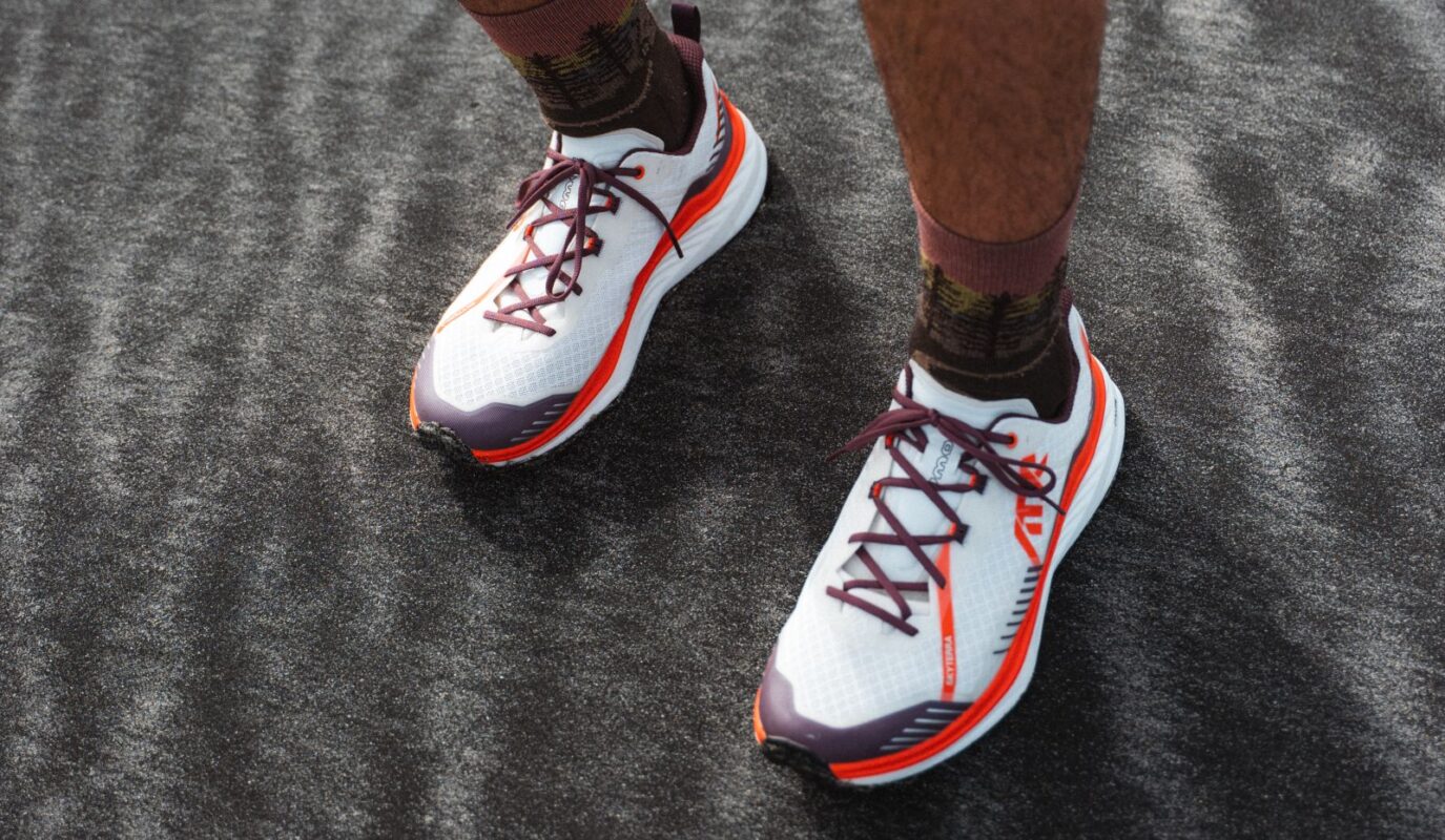 SKYTERRA shoes from an aerial shot of a man wearing them on a black sand beach