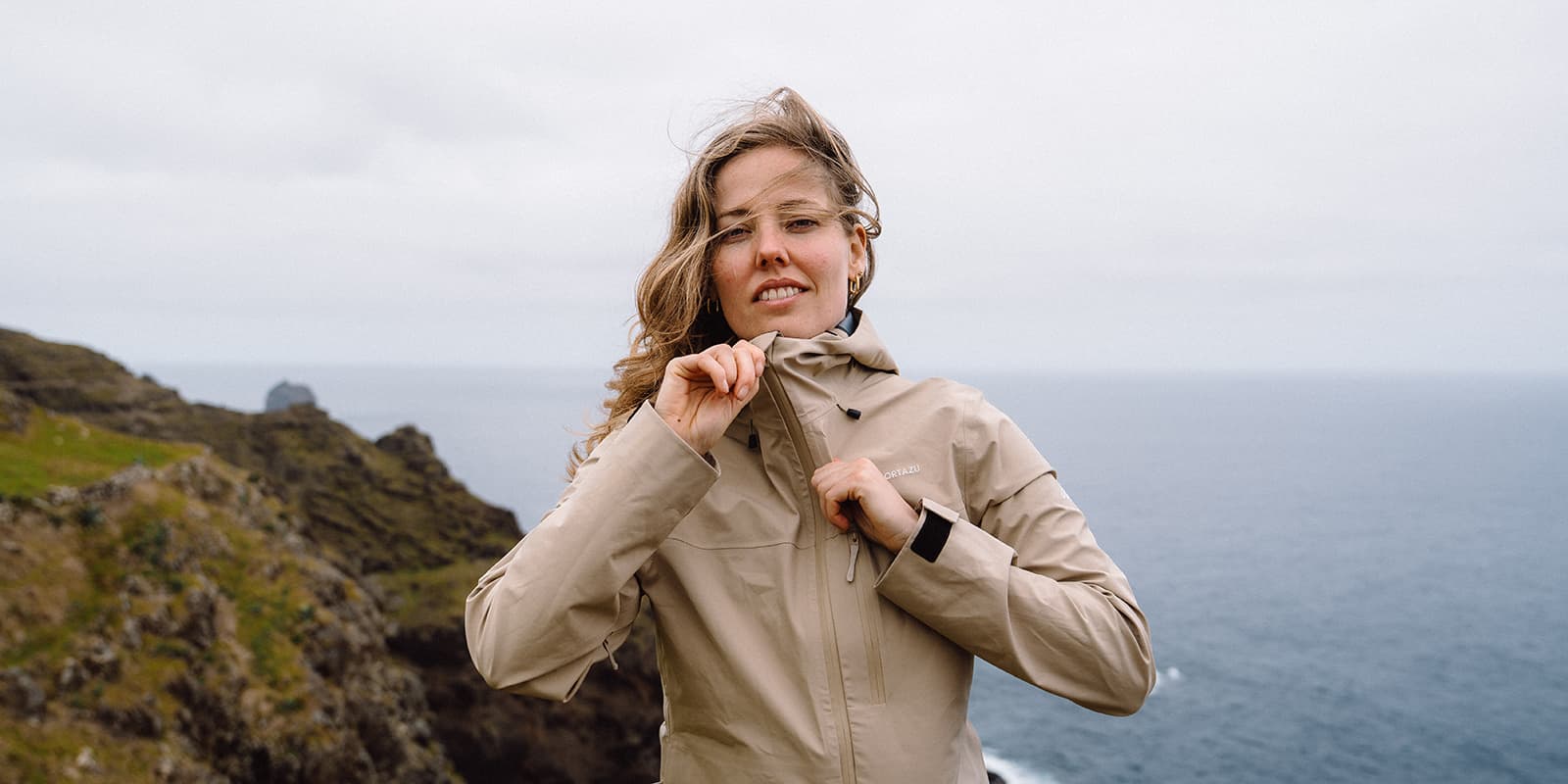 person zipping up Cortazu AR hardshell jacket
