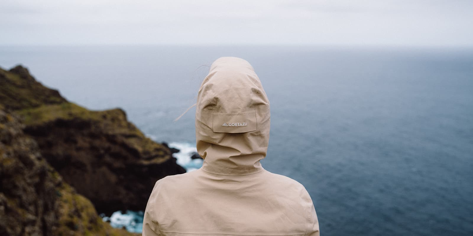 jacket hood from behind with ocean in background