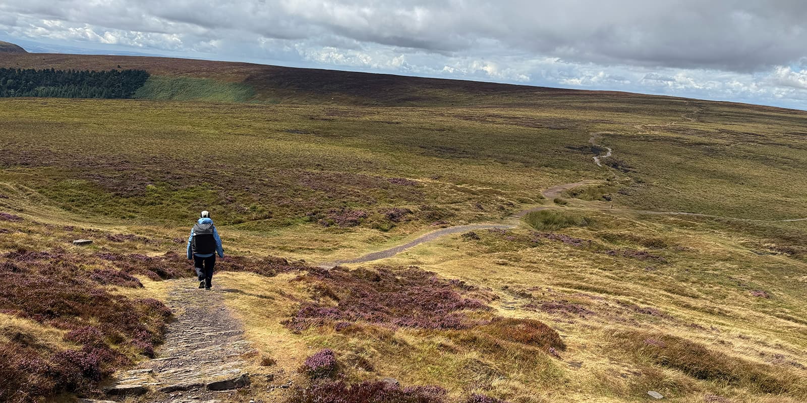 person hiking down hill in Wales on the Offa's Dyke Path