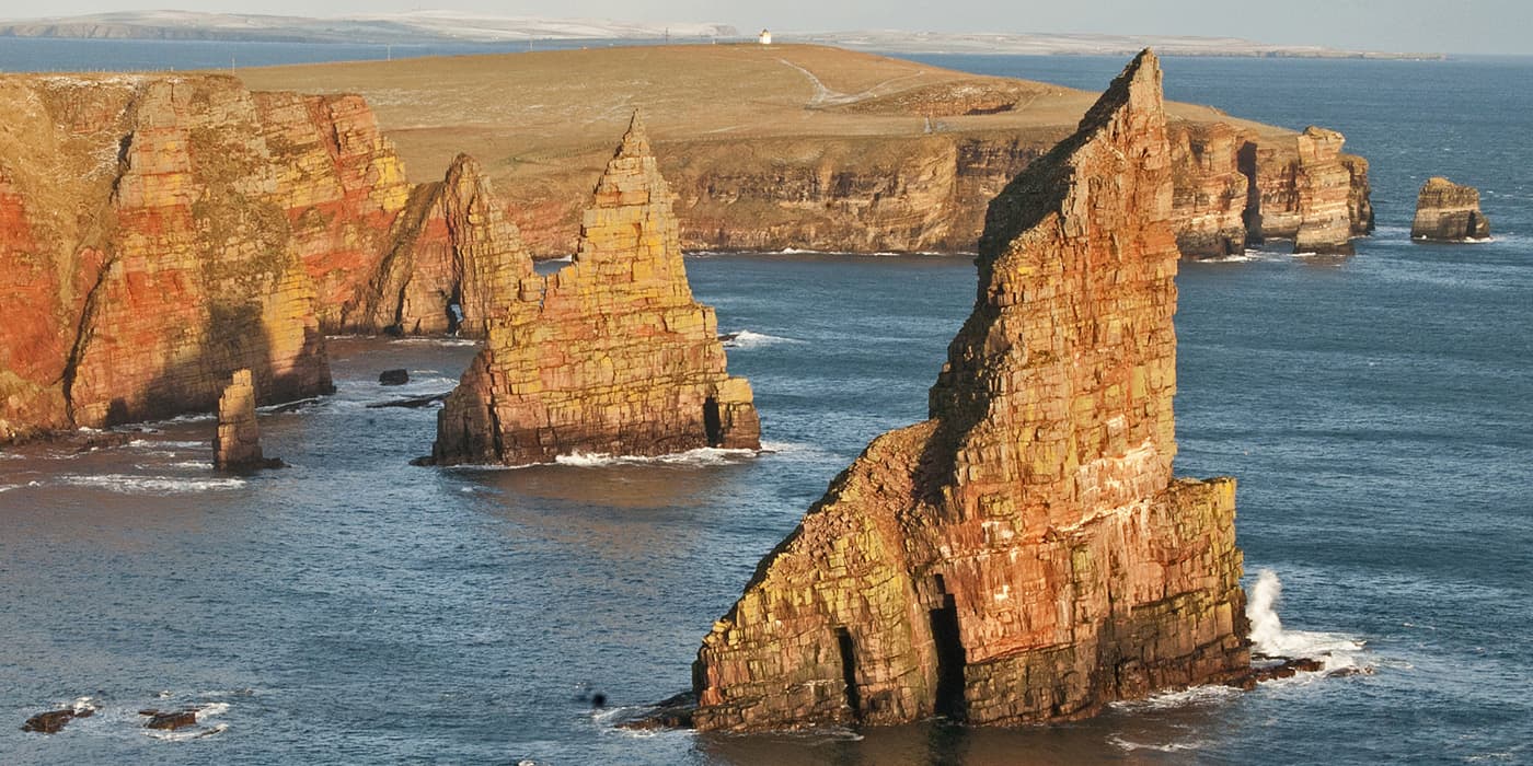 rugged peaks in the water on coastline of Scotland