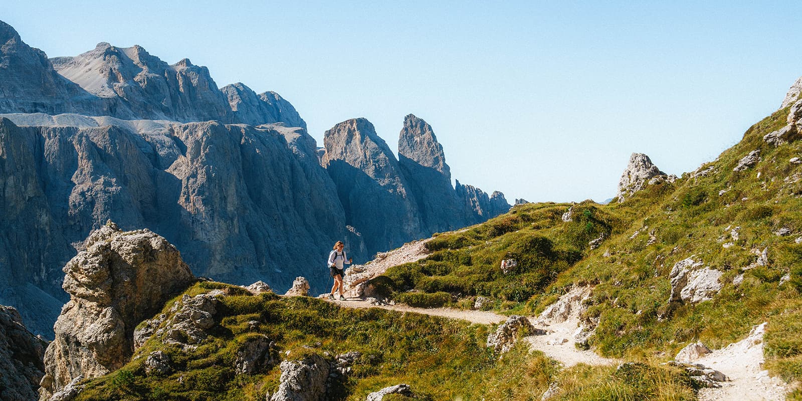 women hiking with dolomites in the background